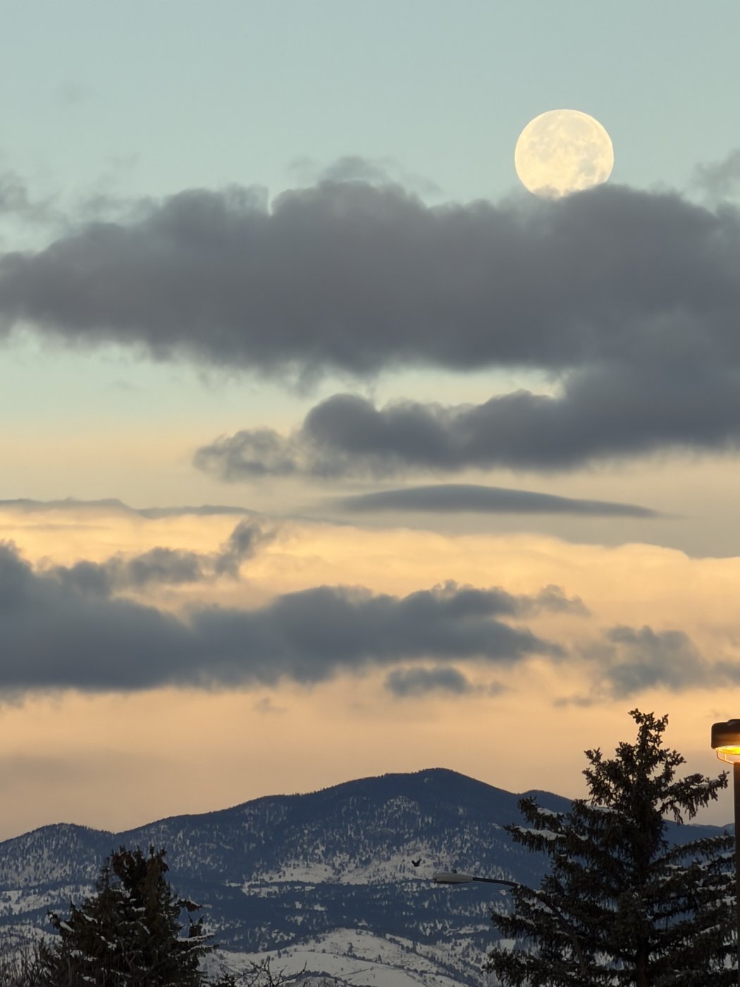 Moon above a mountain landscape at dusk