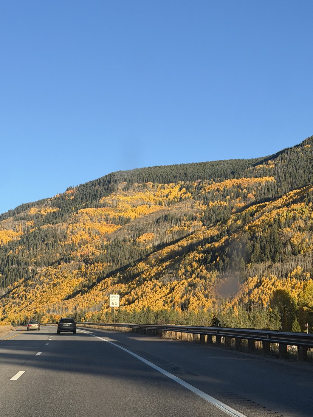 A winding road through golden autumn mountains